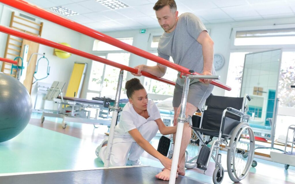 Therapist helping patient to walk